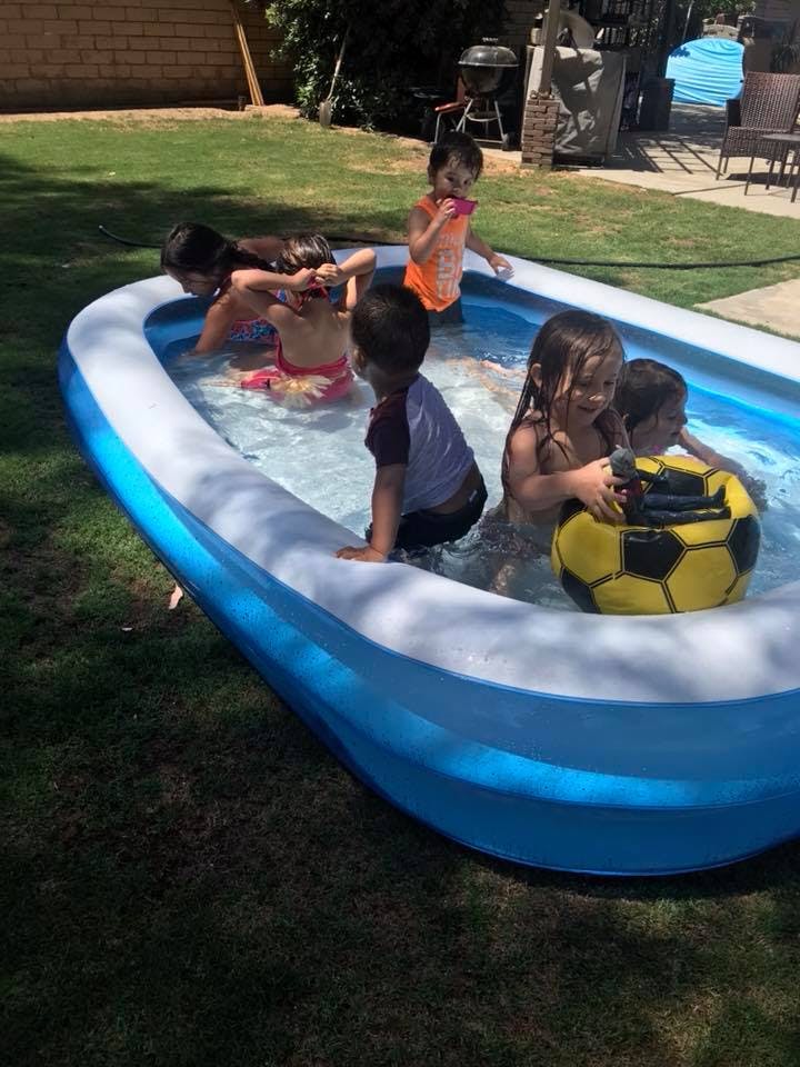 Children playing in an inflatable pool