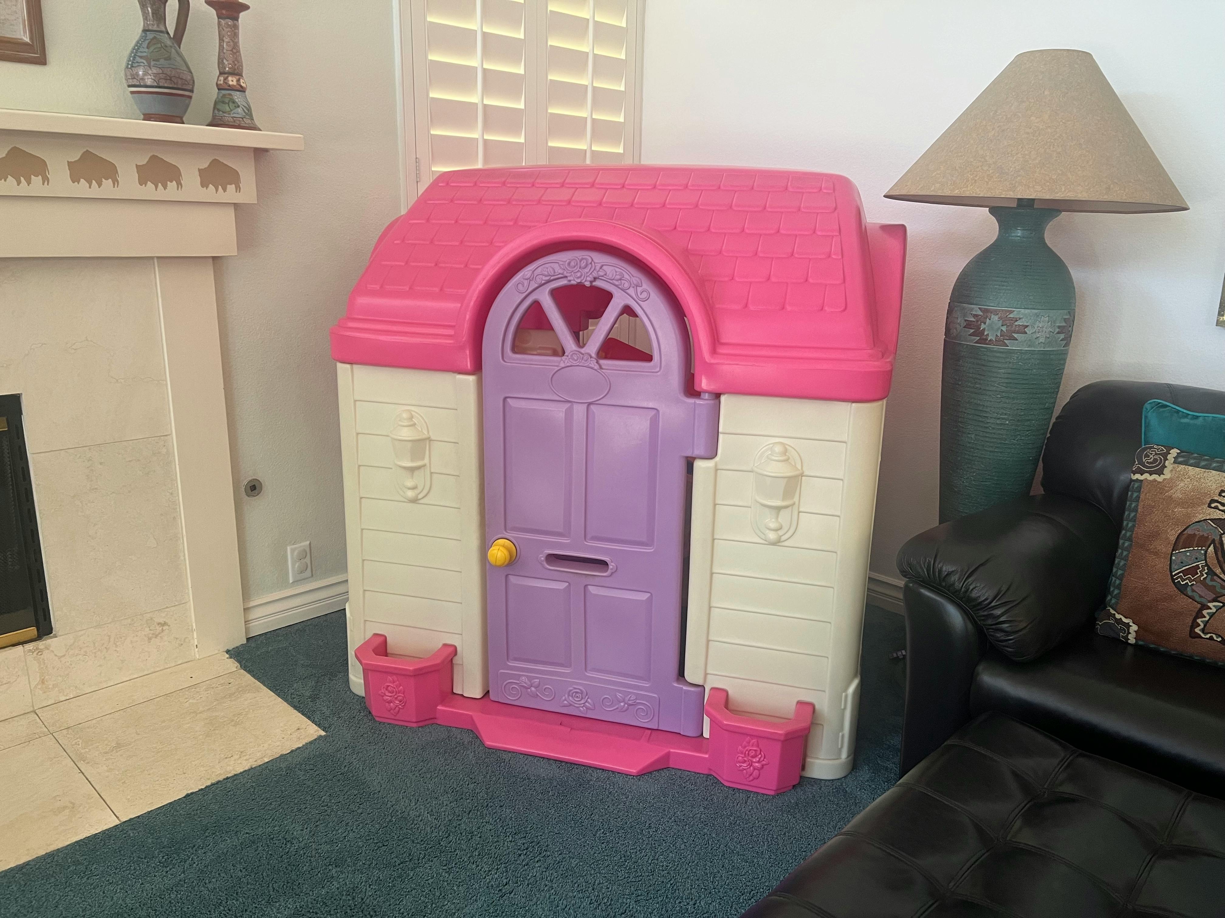 Pink and purple plastic playhouse