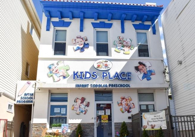 Kids Place building with blue trim and cartoon child cutouts