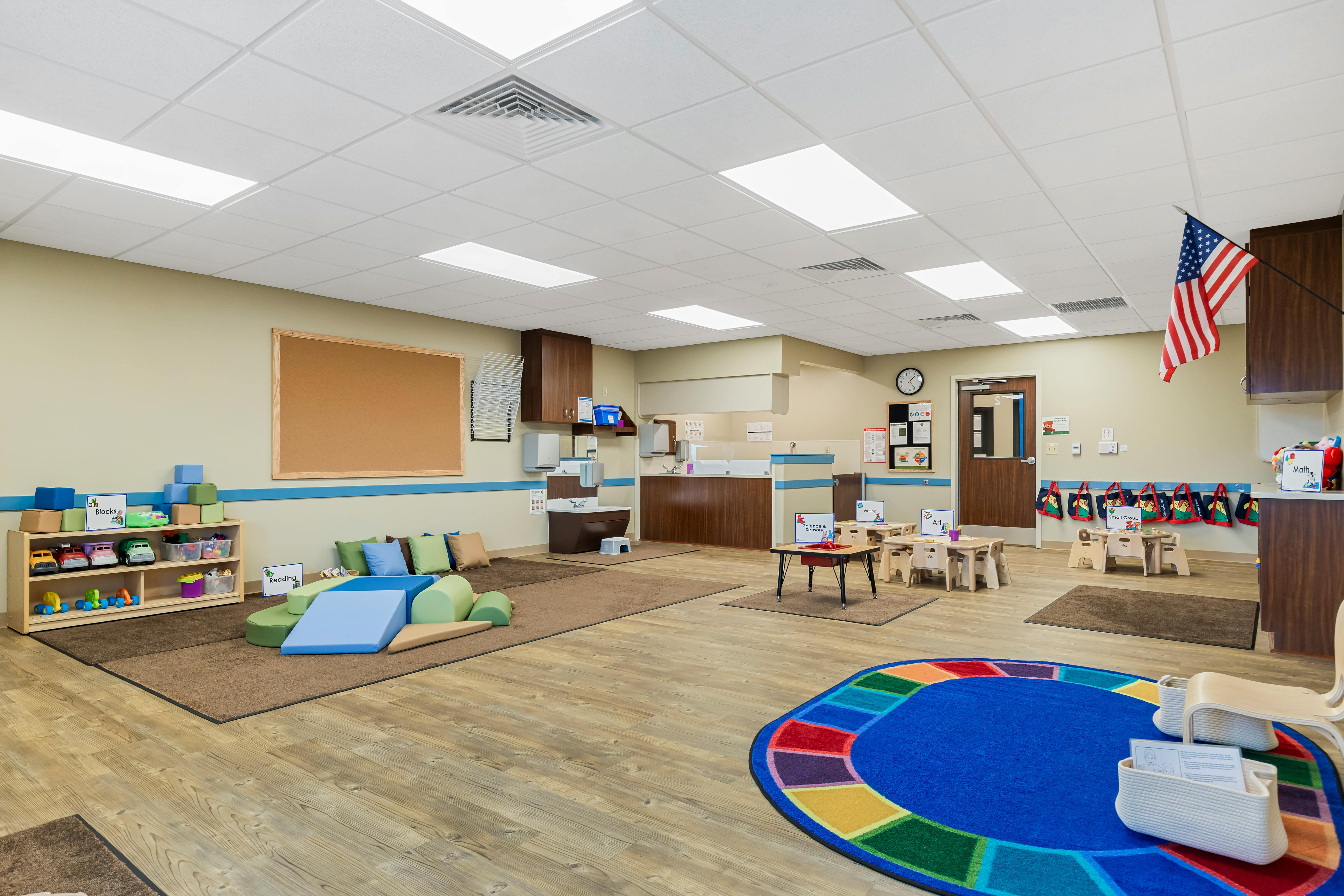 Classroom with play areas for blocks, reading, and small groups
