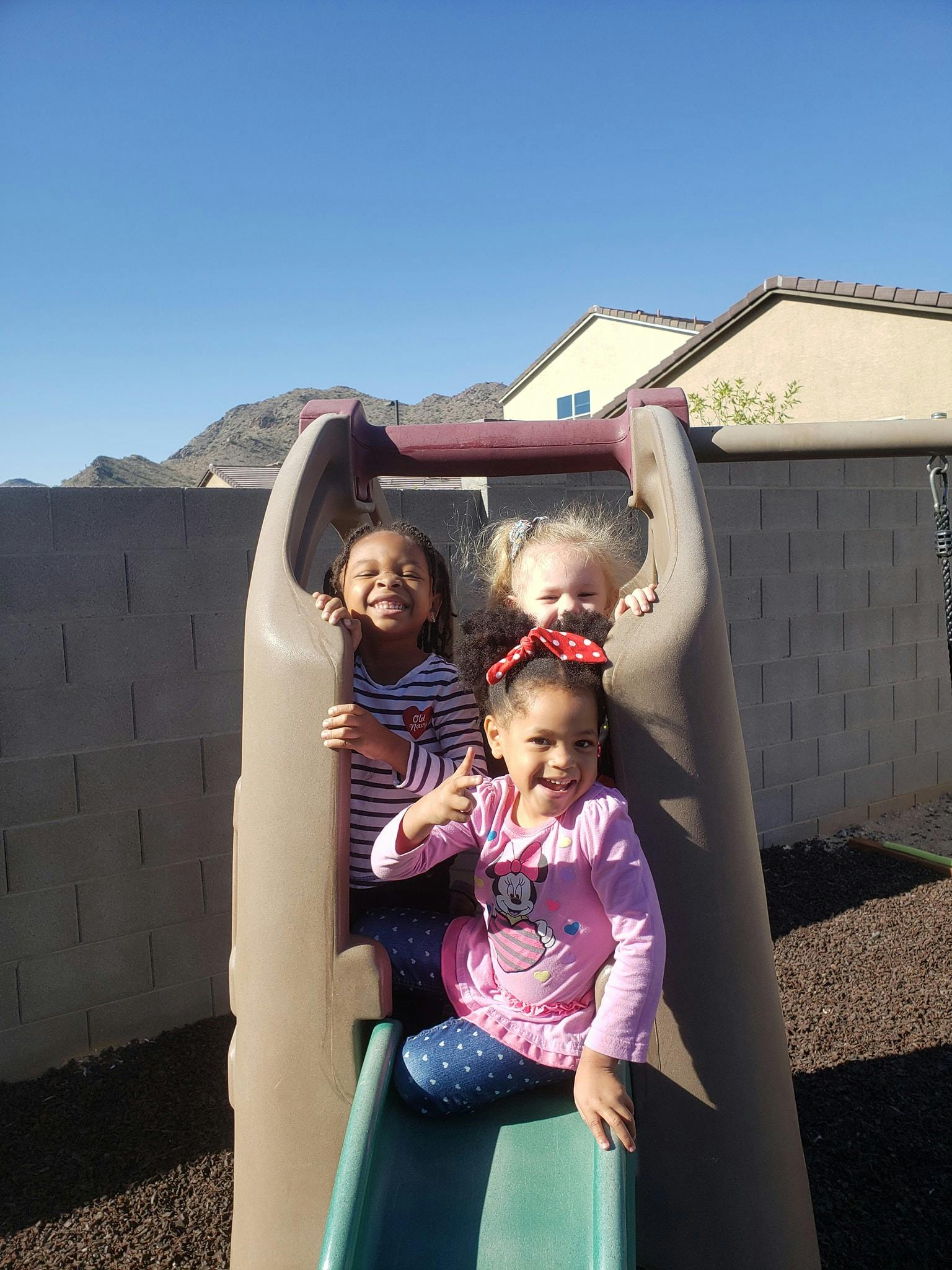 Three children on a playground slide