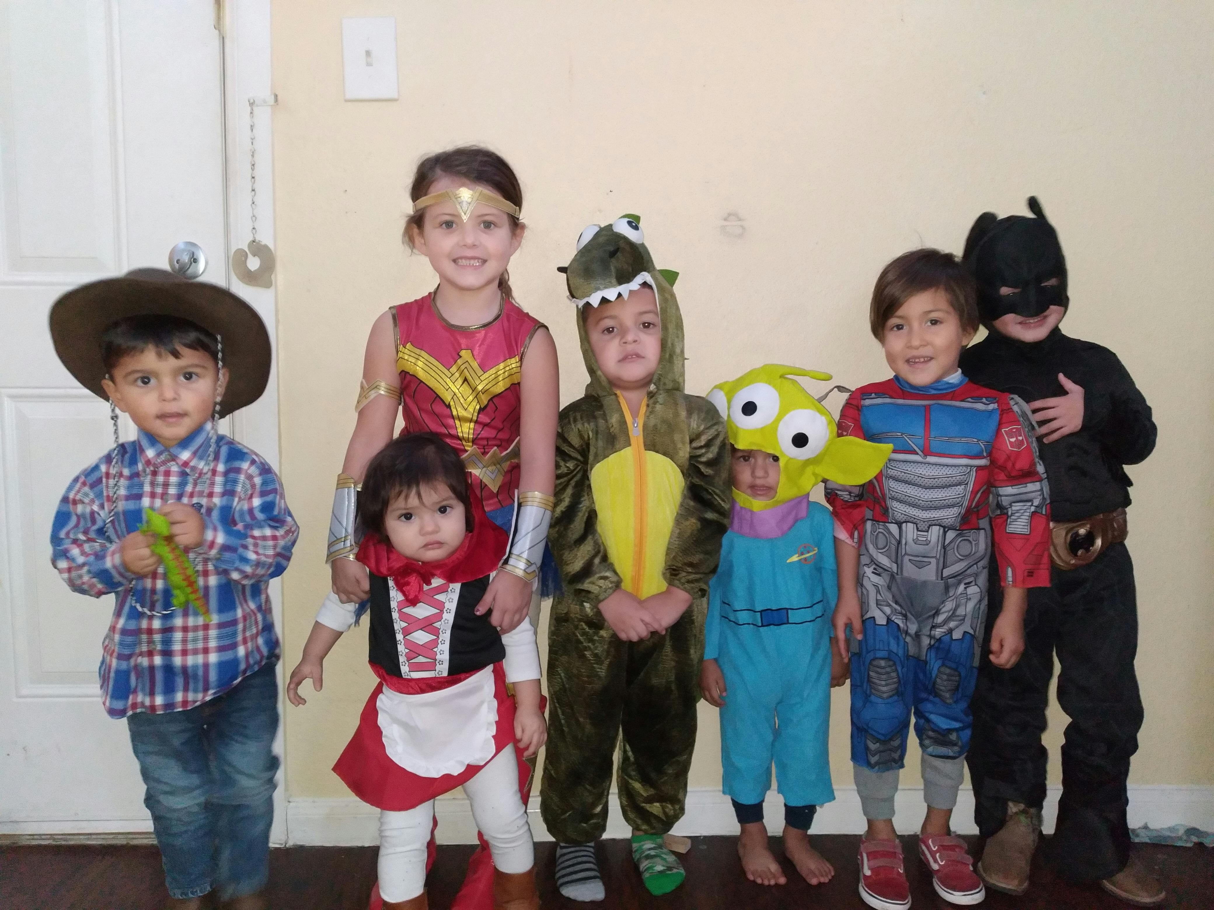 Group of children in various costumes standing together