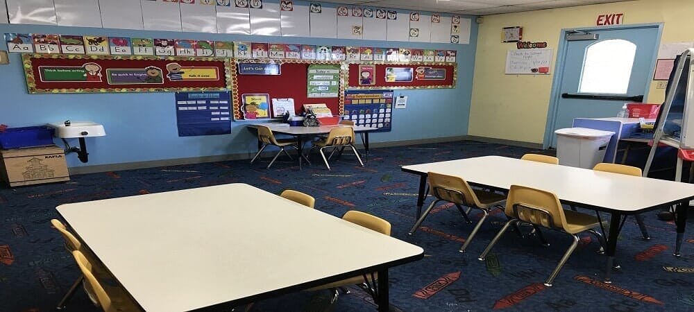 Empty classroom with tables and chairs