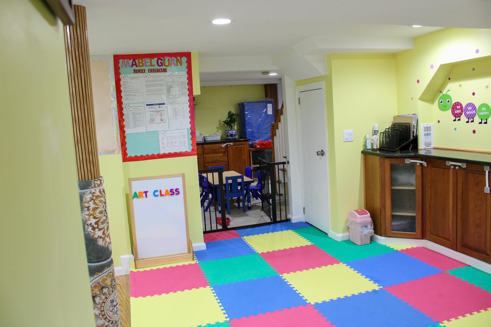 Playroom with colorful floor mats and an "Art Class" sign