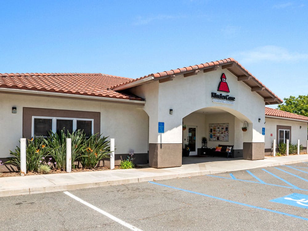 Exterior view of a KinderCare Learning Centers building with a parking lot