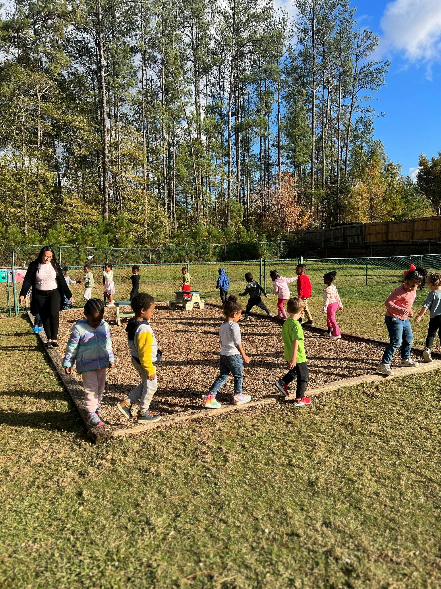 Adult and children walking on a playground