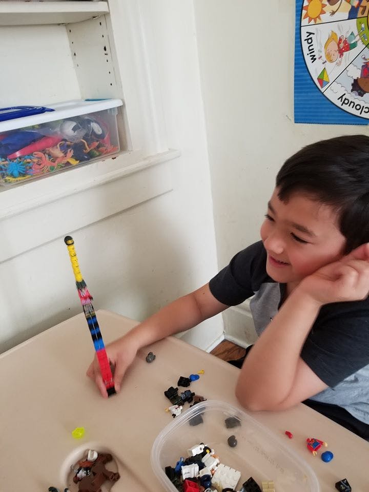 Child building with colorful blocks at a table