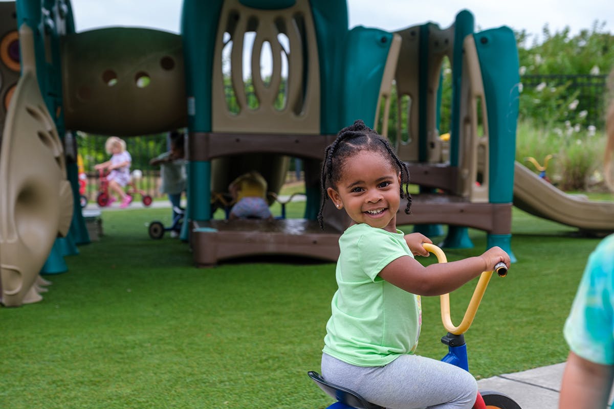 Child on a tricycle on a playground