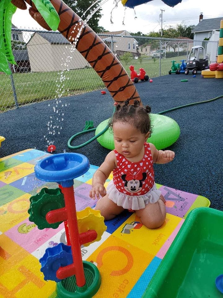 Child playing with water toys outdoors