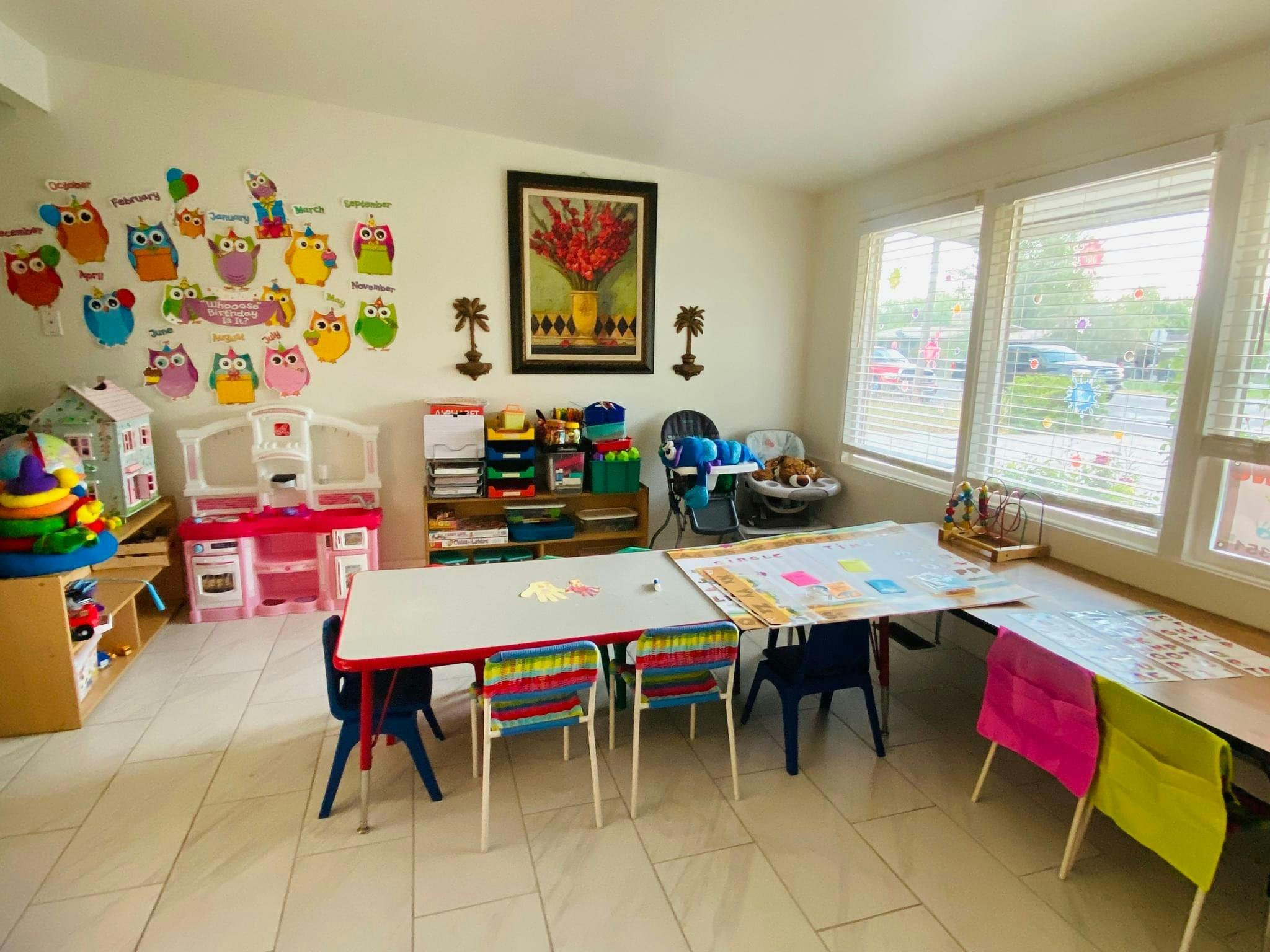 Children's classroom with tables, chairs, and colorful decorations