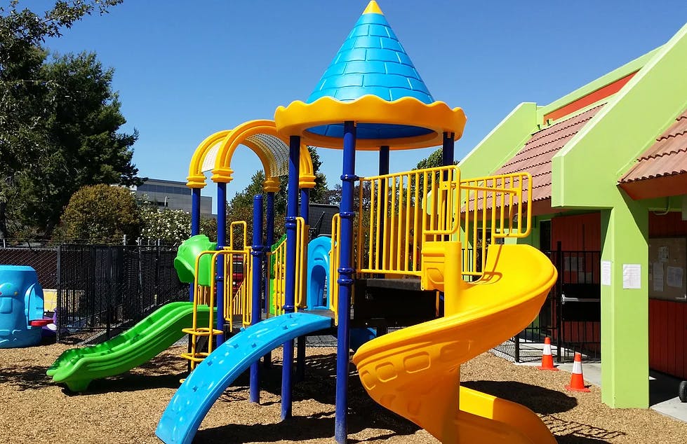 Playground with multiple slides and climbing structures