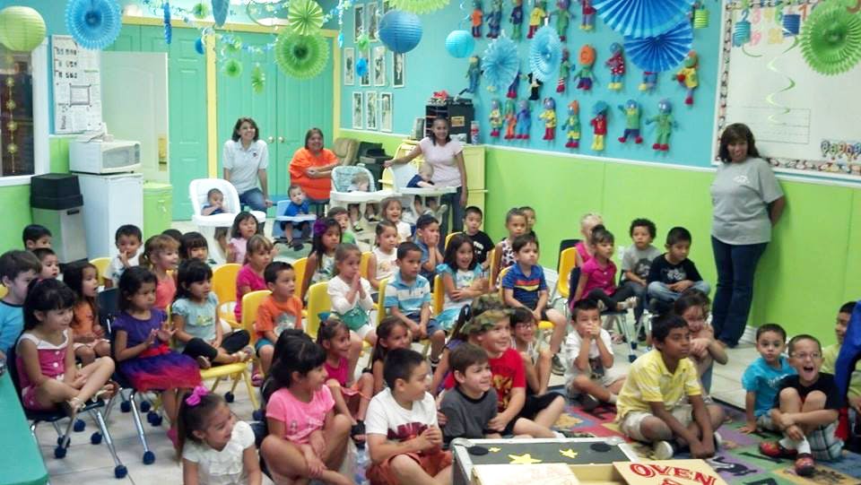 Group of children and adults in a classroom