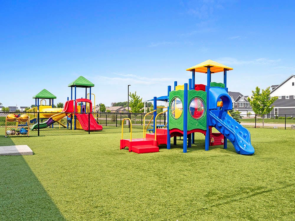 Colorful outdoor playground on green turf