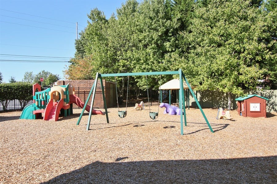 Outdoor playground with swings, slides, and play structures