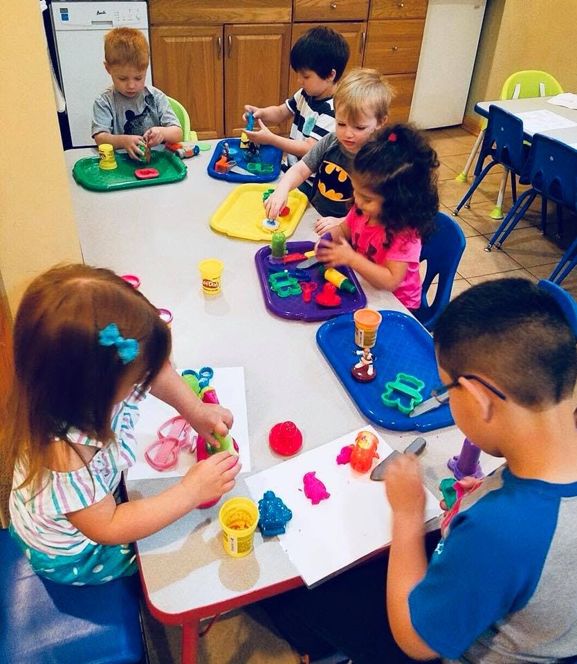 Children playing with modeling clay at a table
