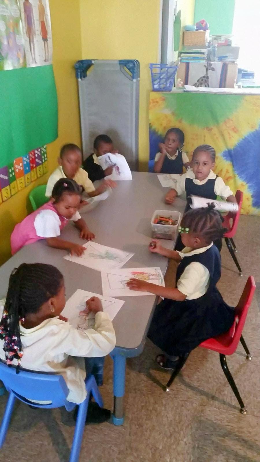 Children sitting at a table drawing