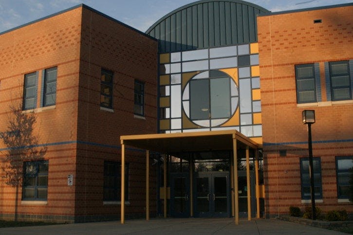 Exterior of a brick building with a covered entrance and geometric window design