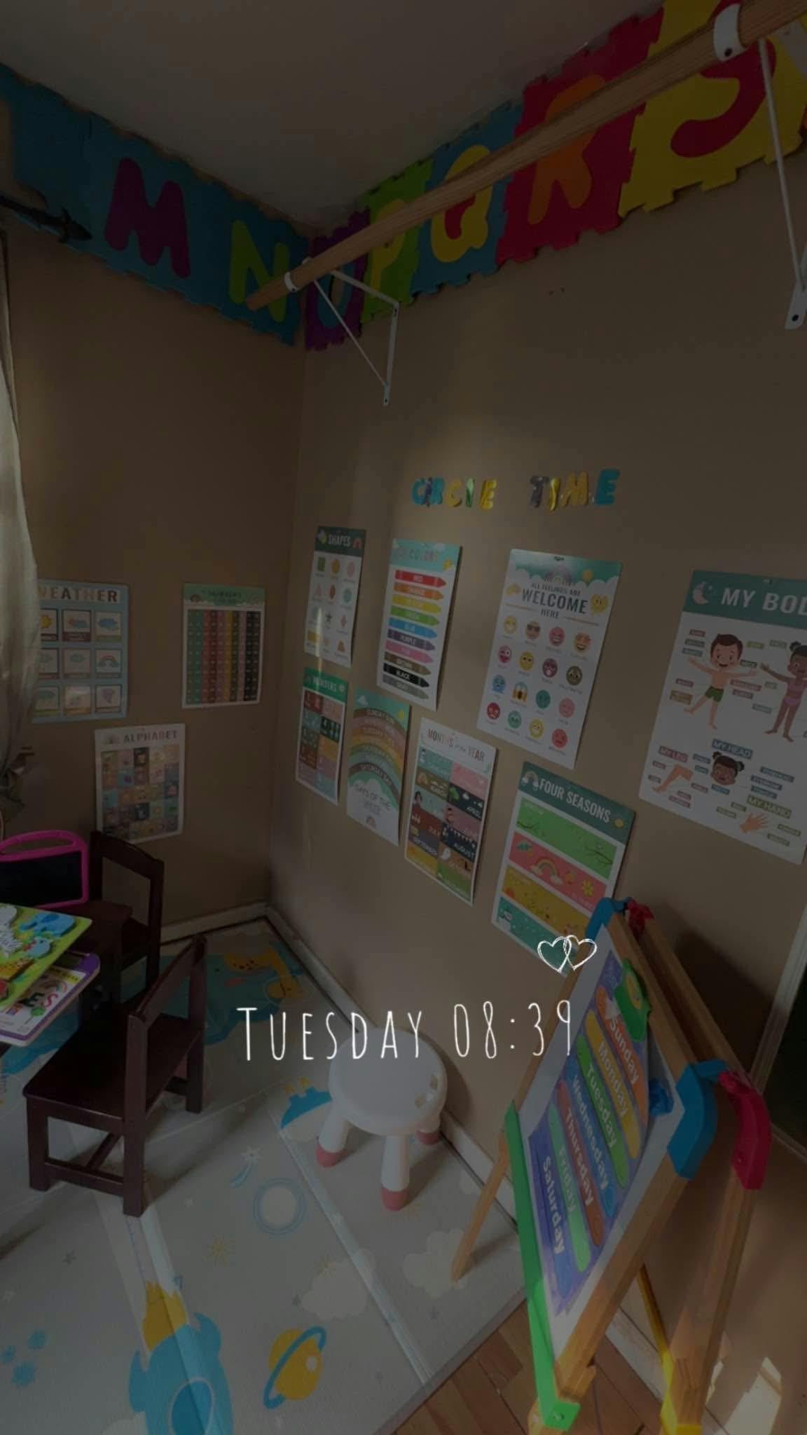 Classroom with educational posters on the wall and child-sized furniture