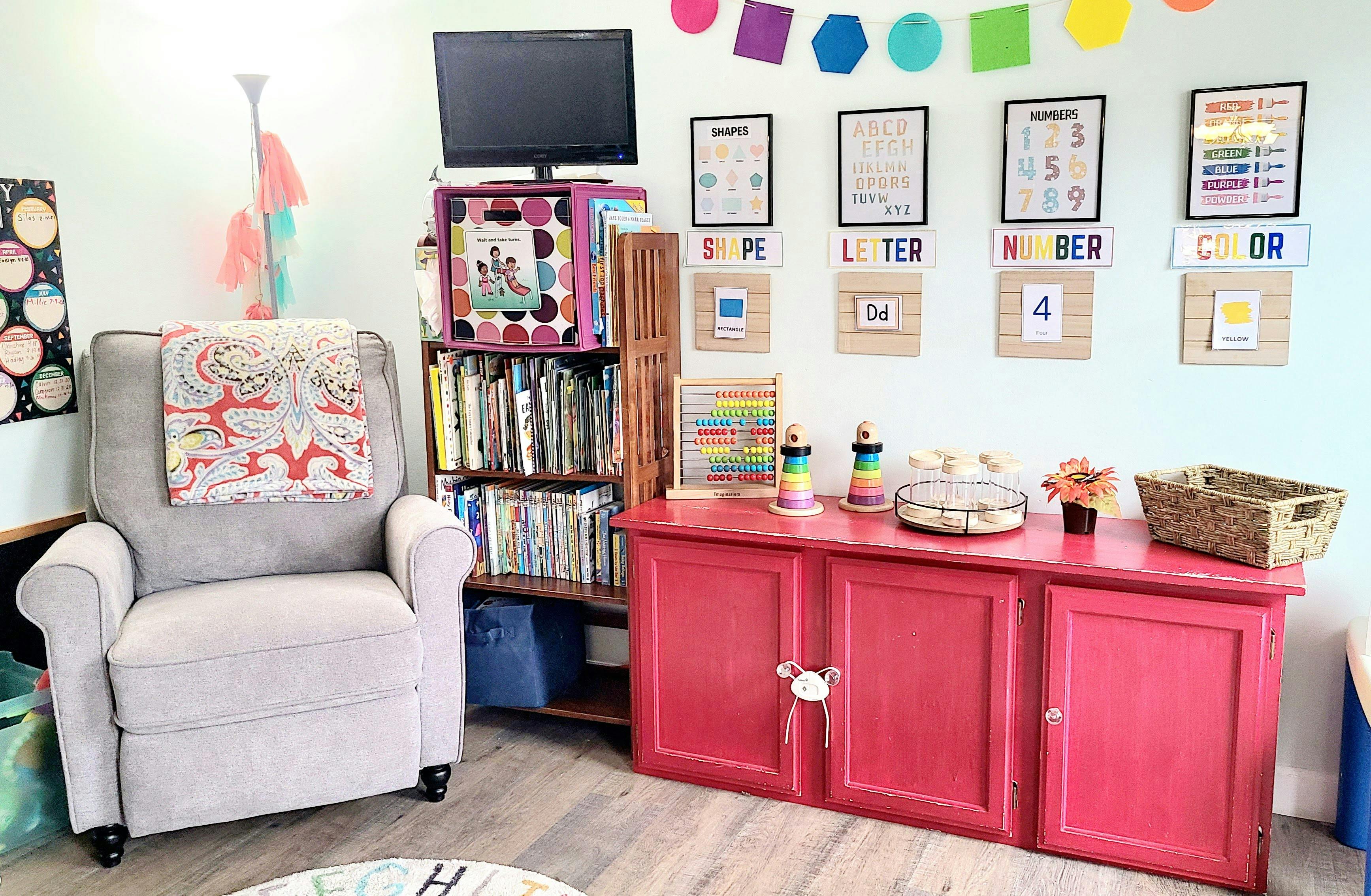 Recliner chair next to a bookshelf and red cabinet in a classroom
