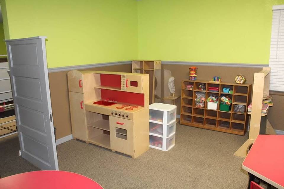 Play kitchen set and storage shelves in a classroom