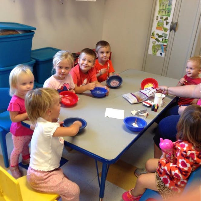 Children sitting at a table with bowls