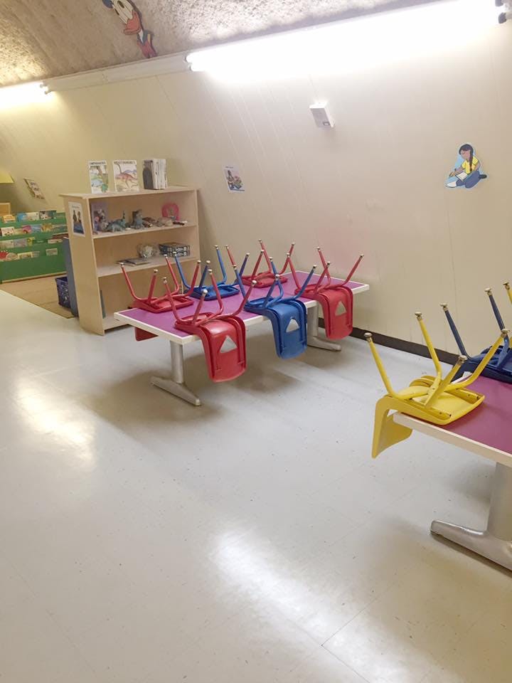 Classroom with chairs inverted on tables