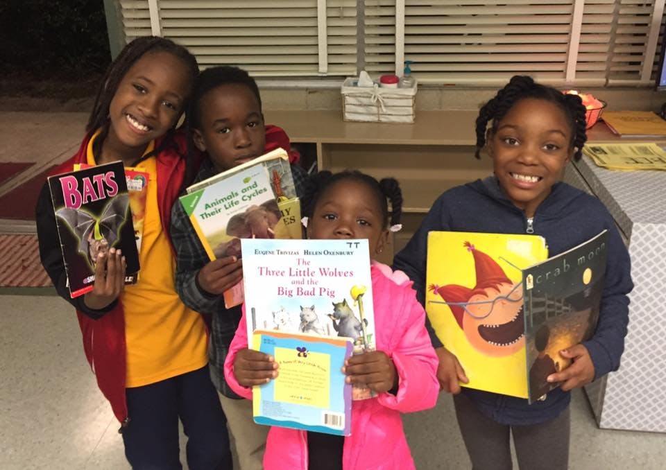 Four children holding books