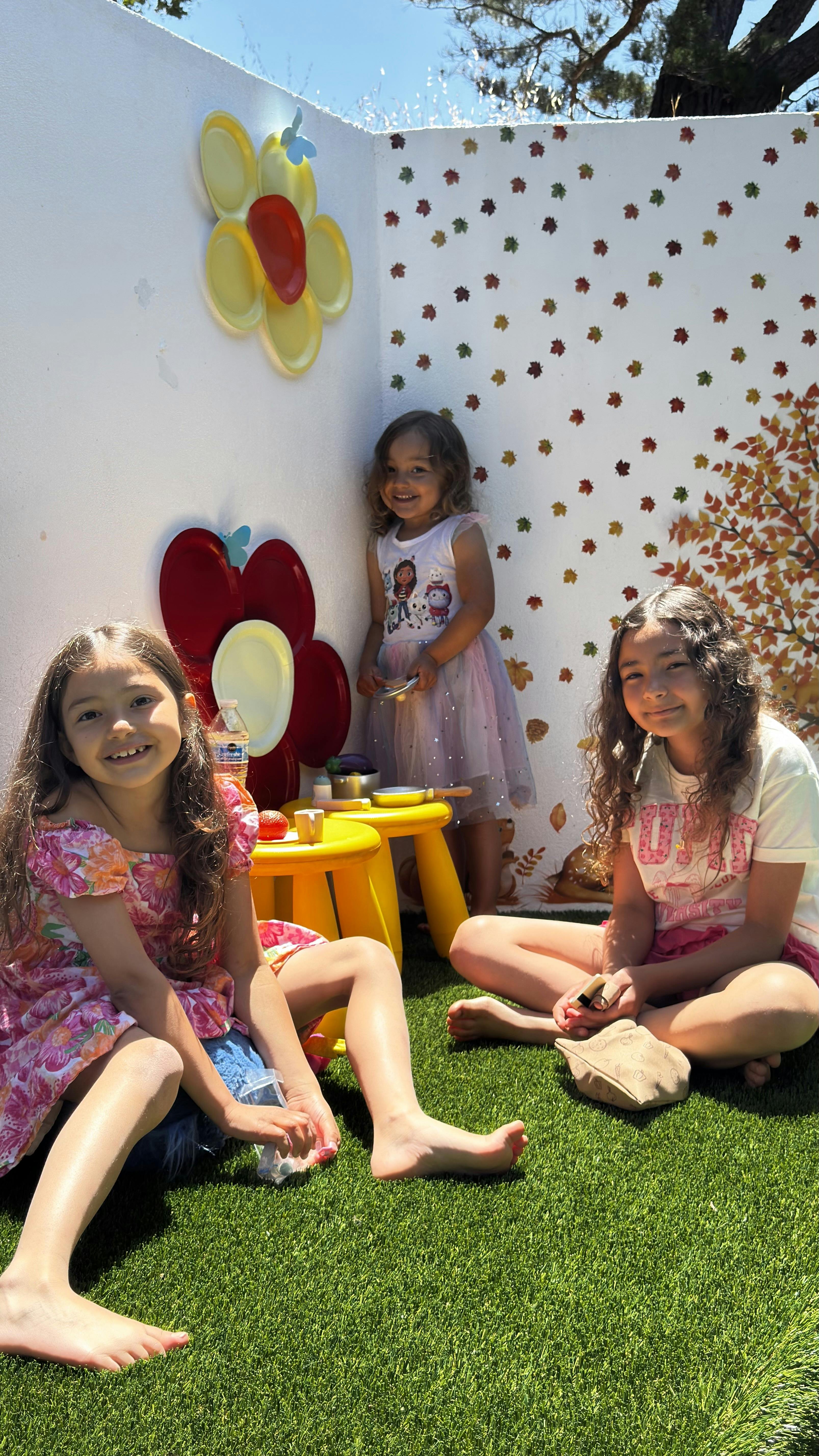Three children playing on artificial grass