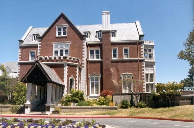 Large brick building with a covered entrance and multiple windows
