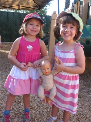 Two children holding a doll
