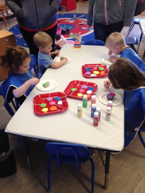 Children painting at a table
