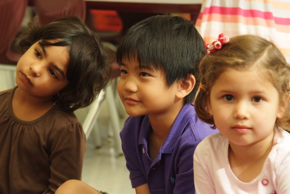 Three children looking in different directions
