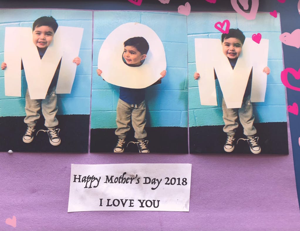 Three children holding letters spelling "MOM" with "Happy Mother's Day 2018 I LOVE YOU" text