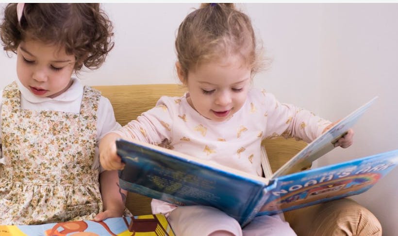 Two children looking at books