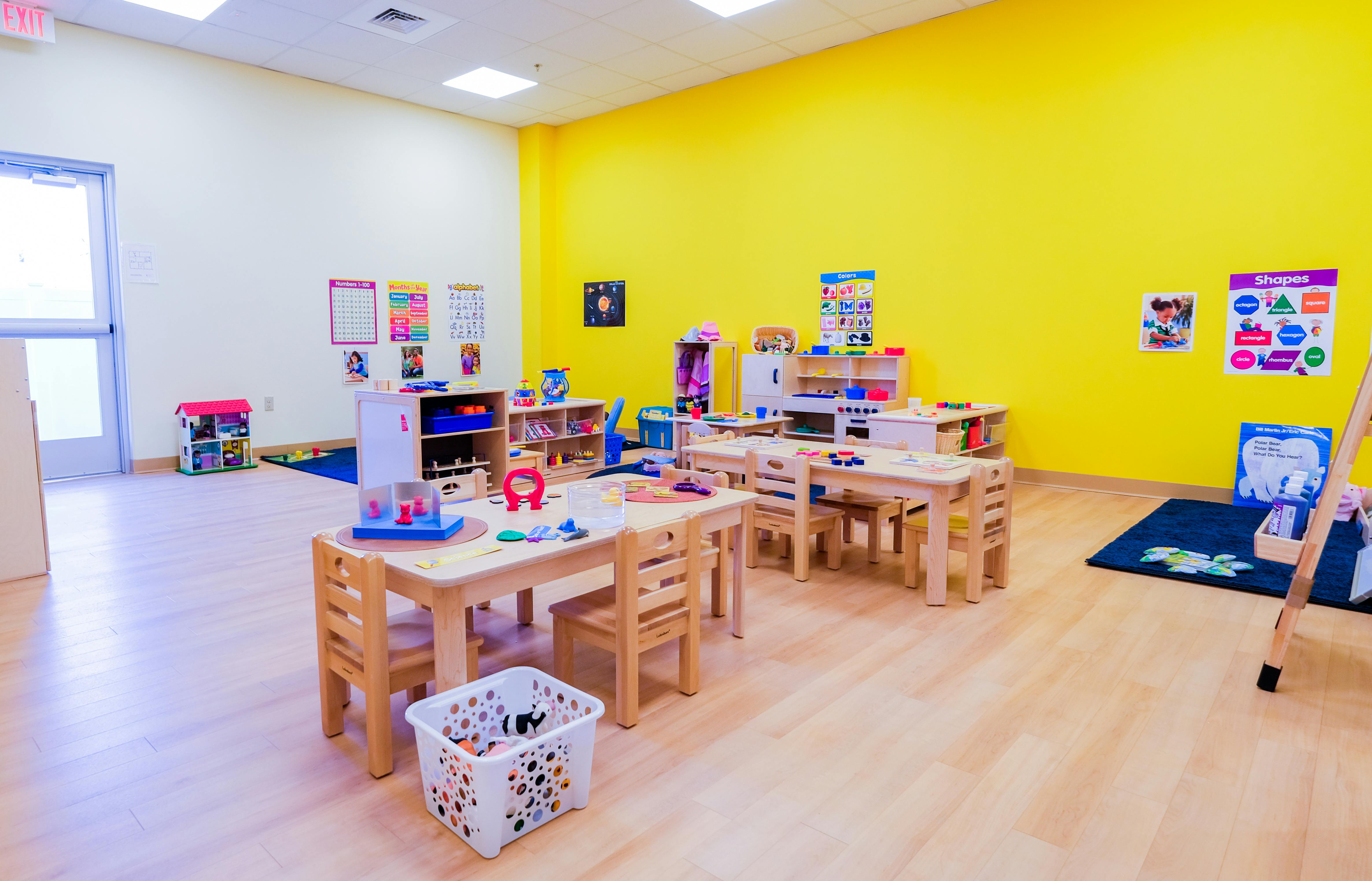 Empty classroom with small tables and chairs