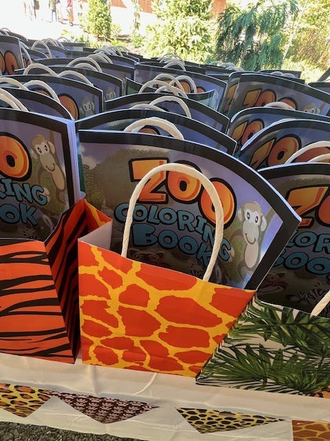 Rows of zoo-themed coloring books in animal print bags