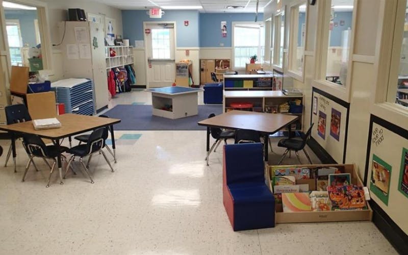 empty classroom with small tables and chairs