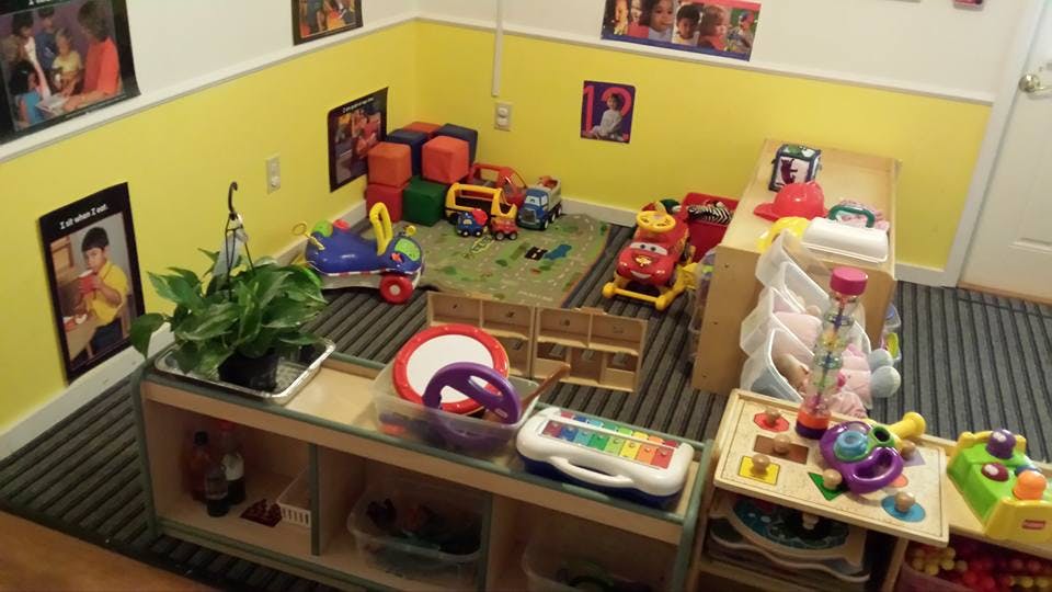 Playroom with toys, including trucks, blocks, and musical instruments