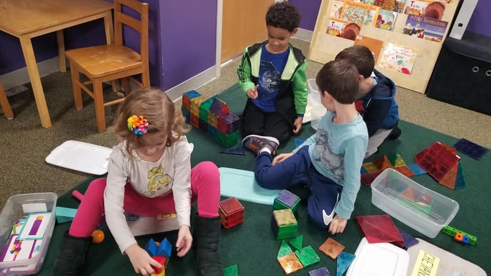 Children playing with colorful blocks on the floor