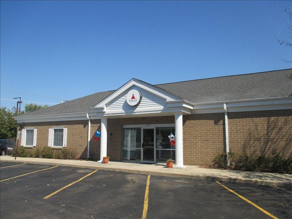 Brick building with white columns and a KinderCare sign