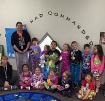 Adult and group of children in pajamas