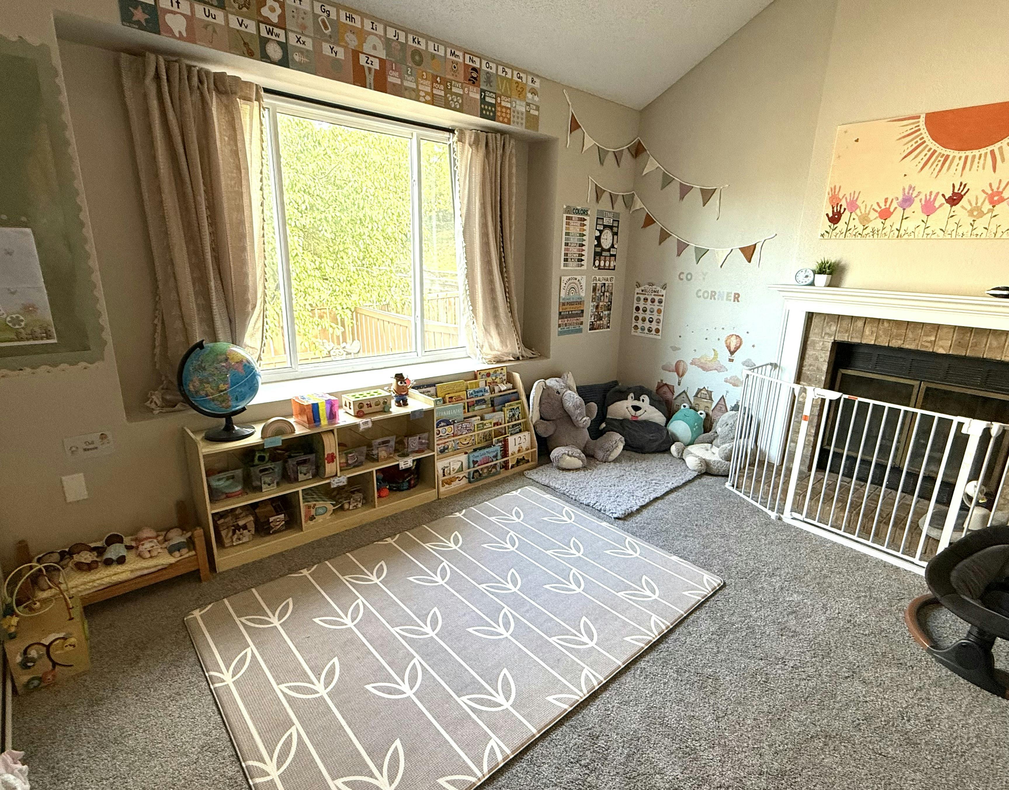 Playroom with shelves of toys and a fireplace behind a safety gate