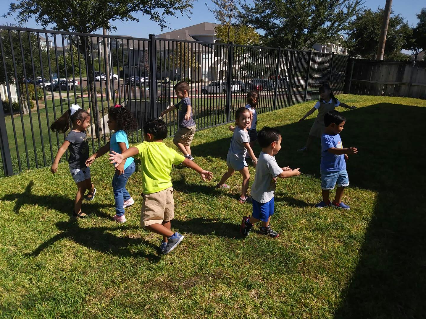 Children playing in a grassy area