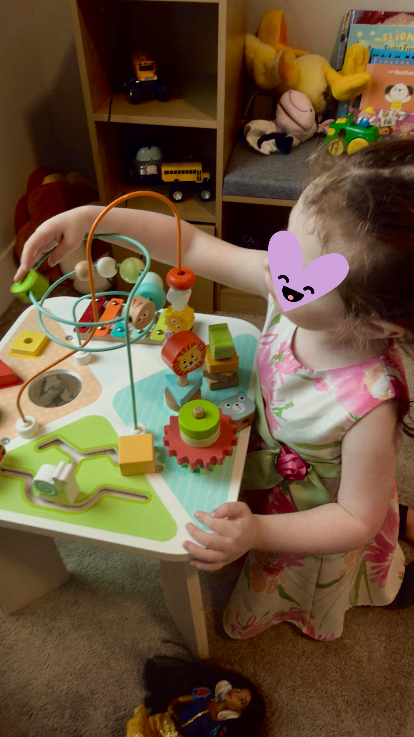 Child playing with a wooden activity table