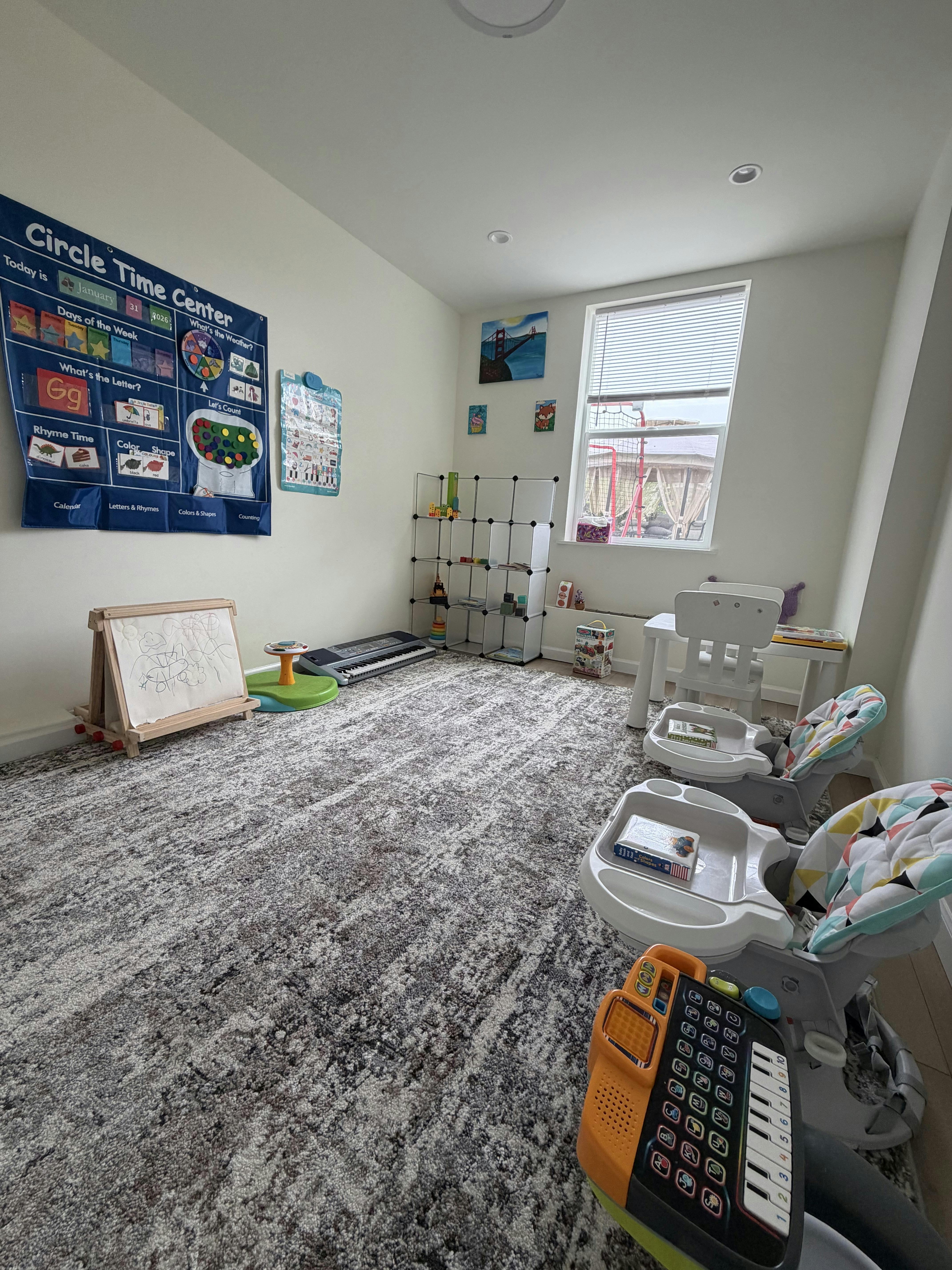 A room set up as a learning center with a "Circle Time Center" chart and various toys