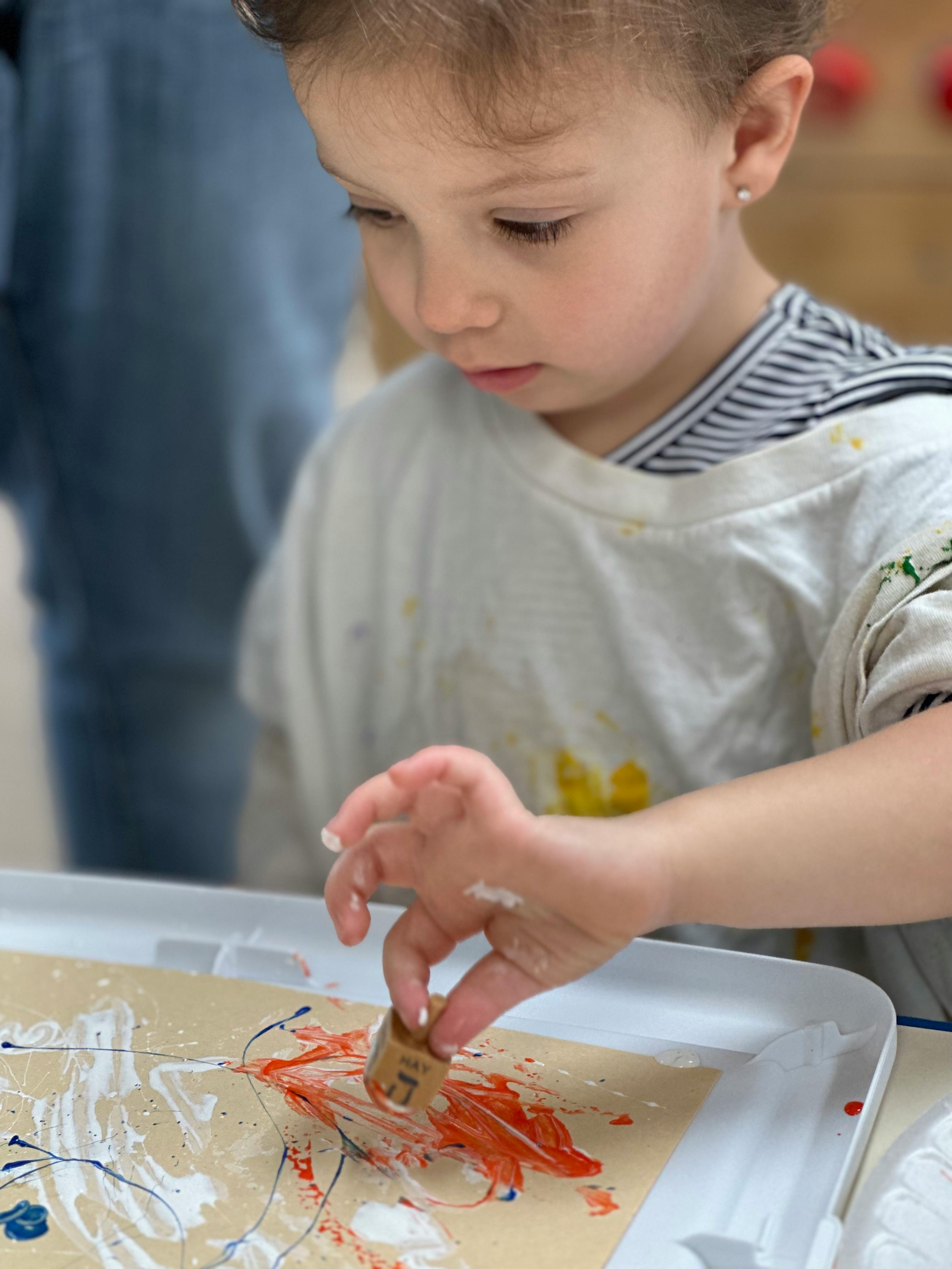 Child painting with a small object