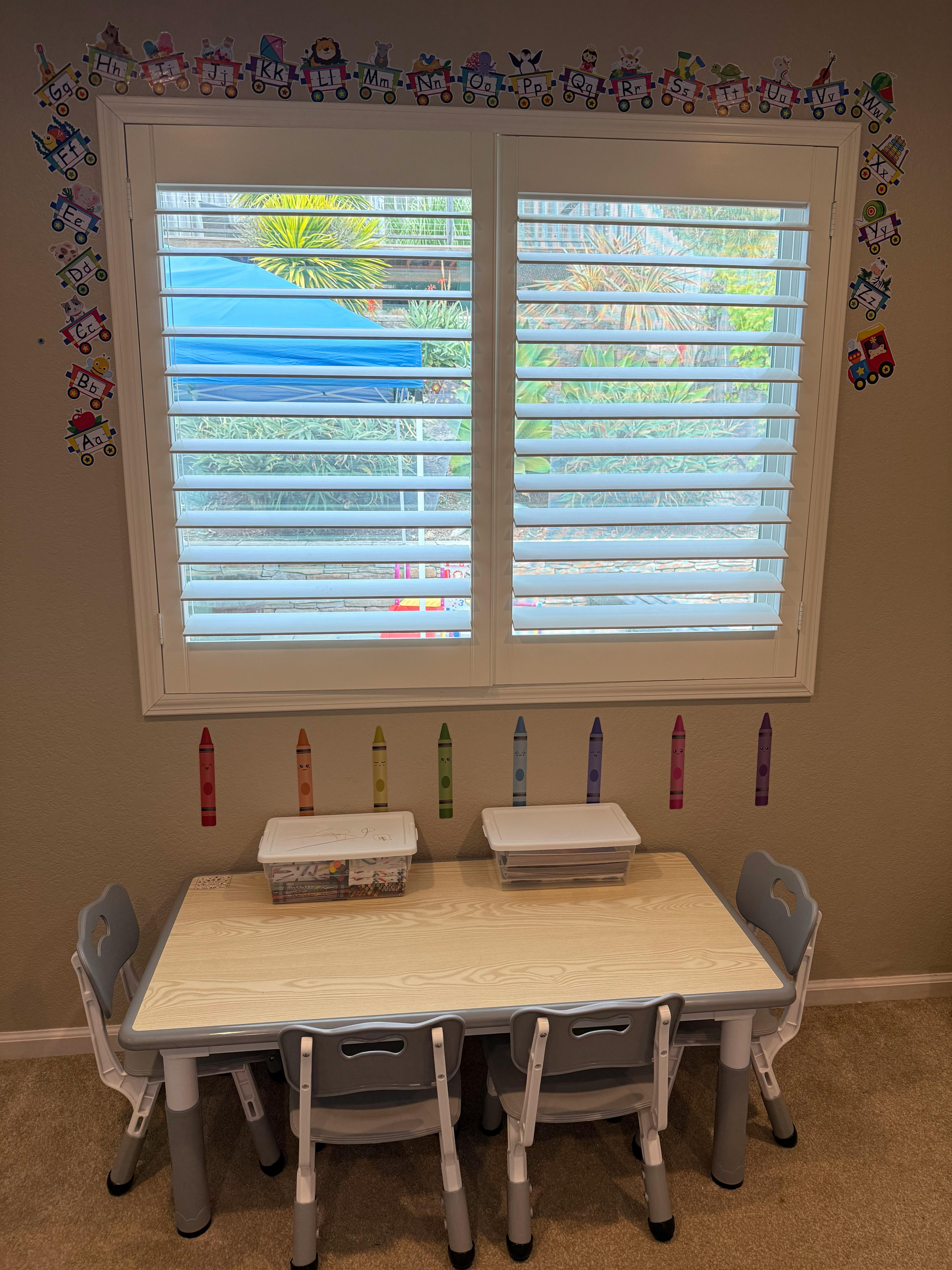 Children's table and chairs in a room with a window