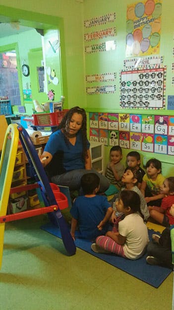 Person teaching a group of children in a classroom