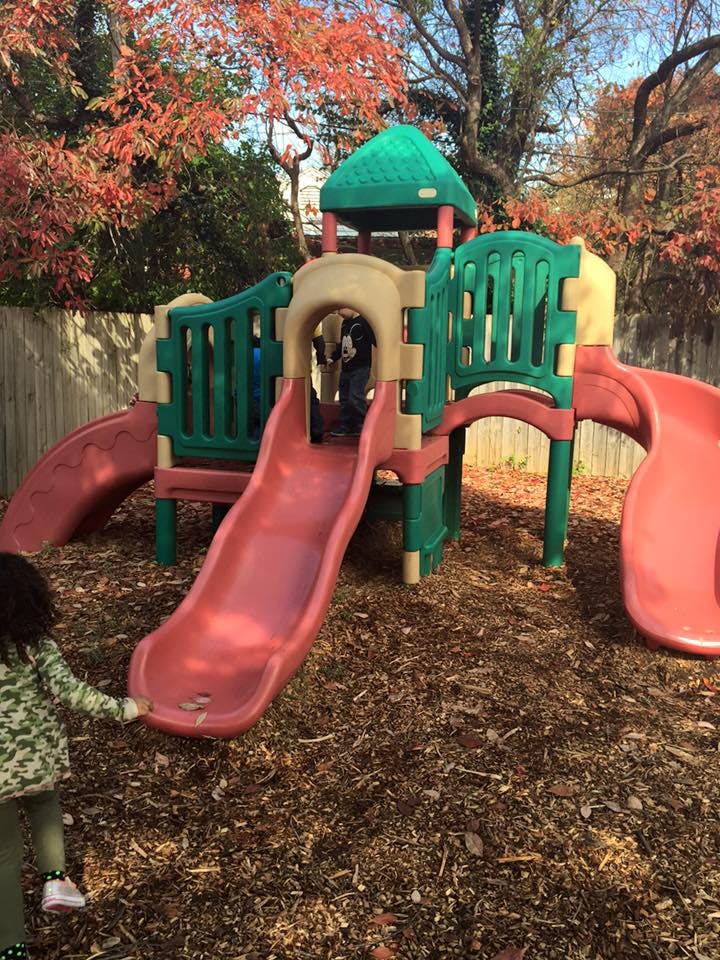 Child on a playground structure with slides