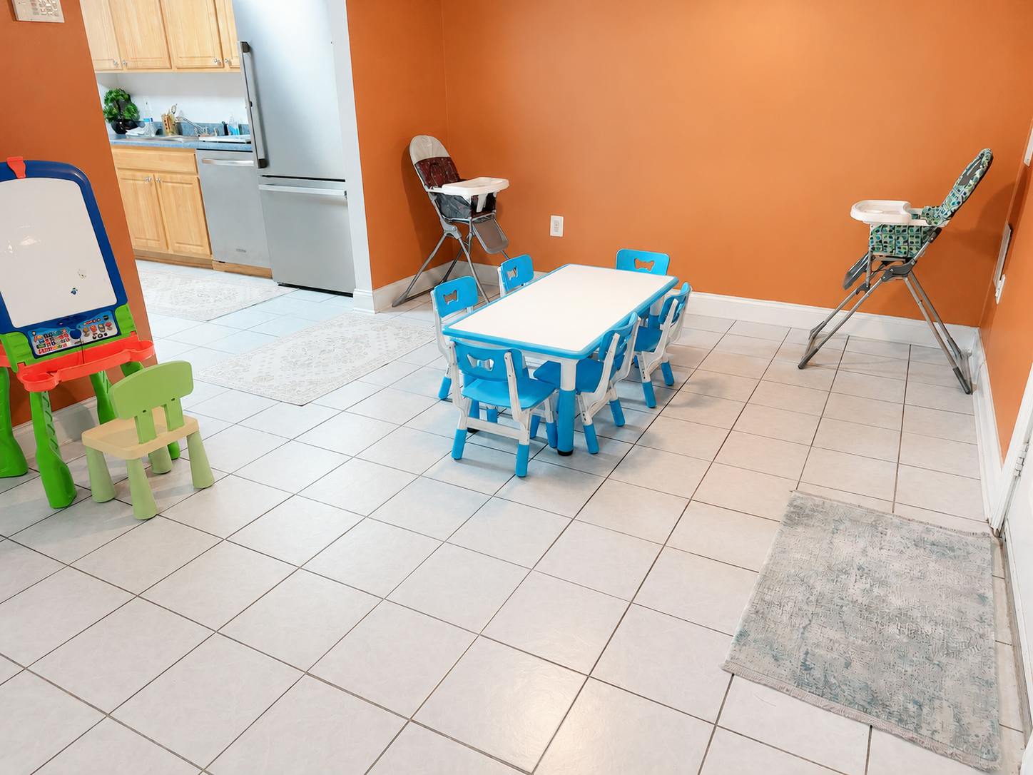 Small table with chairs and high chairs in a play area